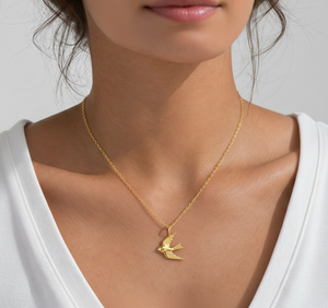 the beehive 18k gold plated brass pendant necklace featuring a 3D soaring bird design worn on a woman