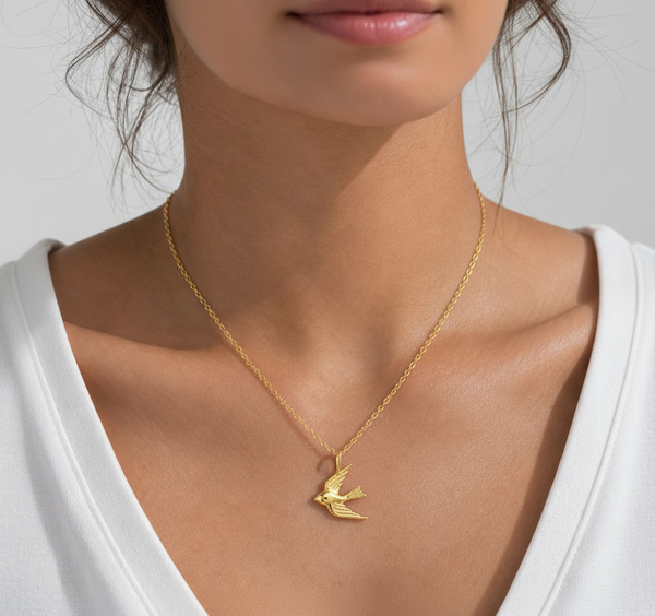 the beehive 18k gold plated brass pendant necklace featuring a 3D soaring bird design worn on a woman